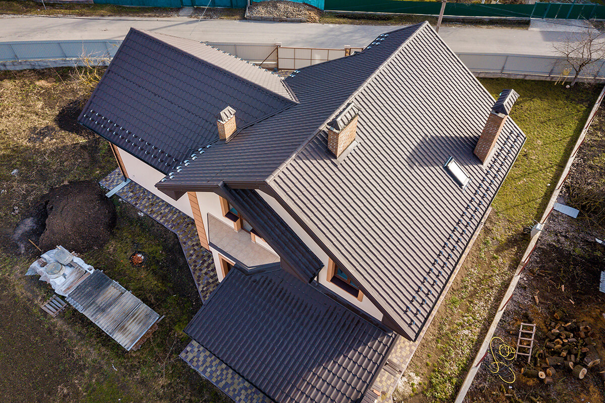 Aerial top view of building steep shingle roof